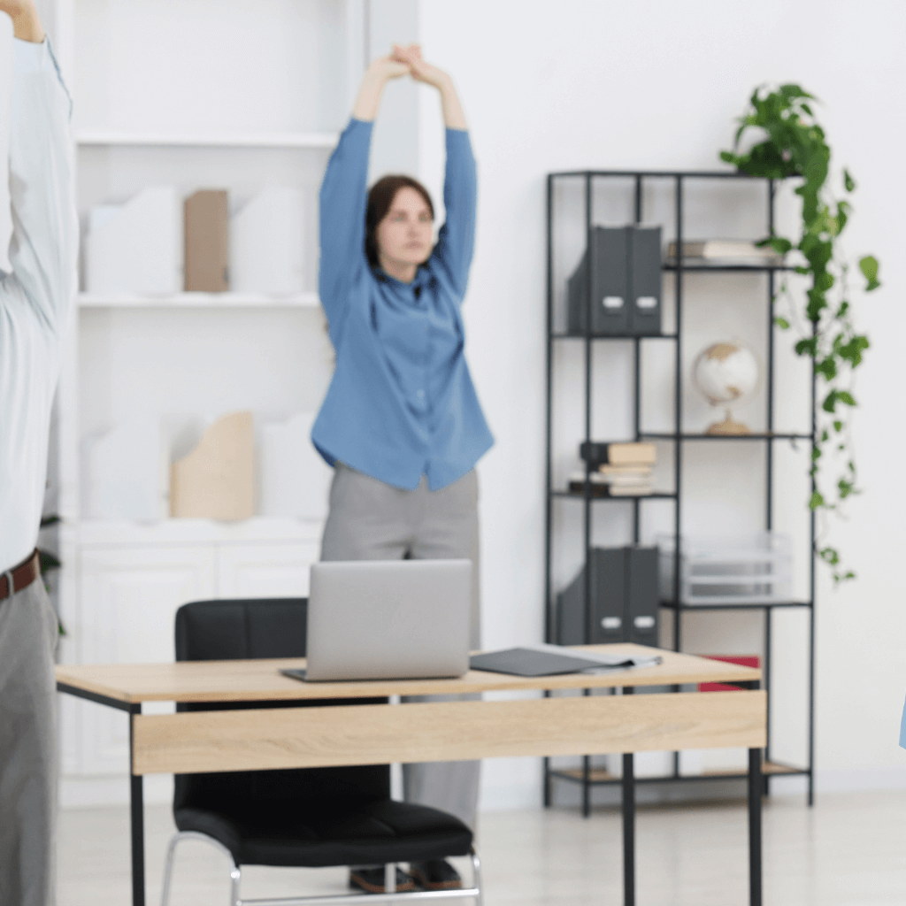 Corporate Wellbeing Programme Dublin. Women stretching at the office.