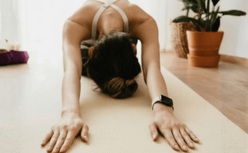women stretching her back - back pain Pilates Dublin | Aoife Moves